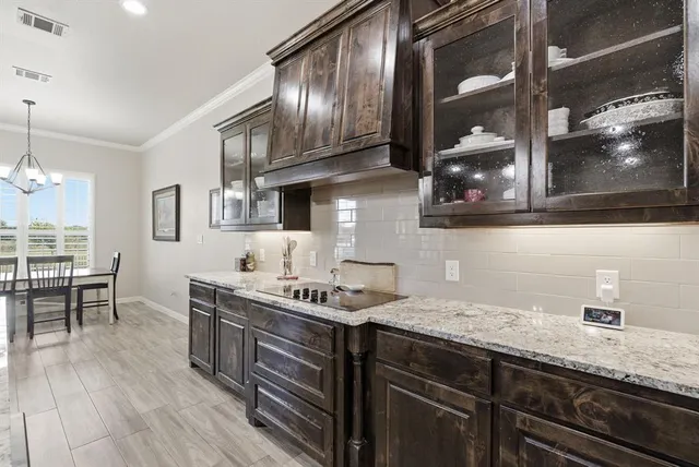 a kitchen with stainless steel appliances granite countertop a sink a stove and cabinets