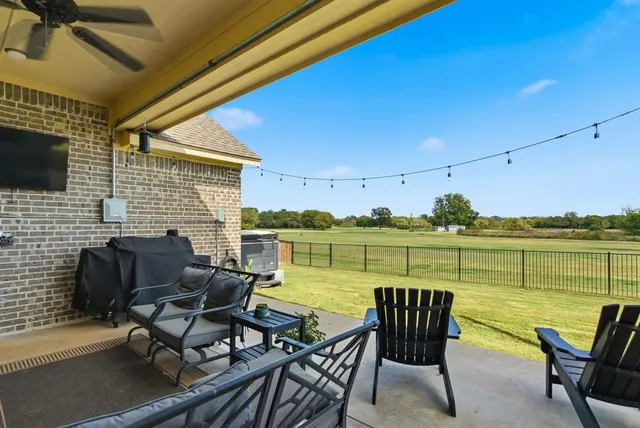 a view of a chairs and table in the patio