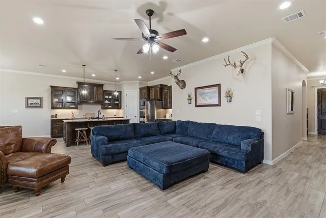 a living room with furniture and kitchen view