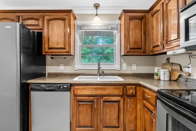 a kitchen with granite countertop a sink and a window