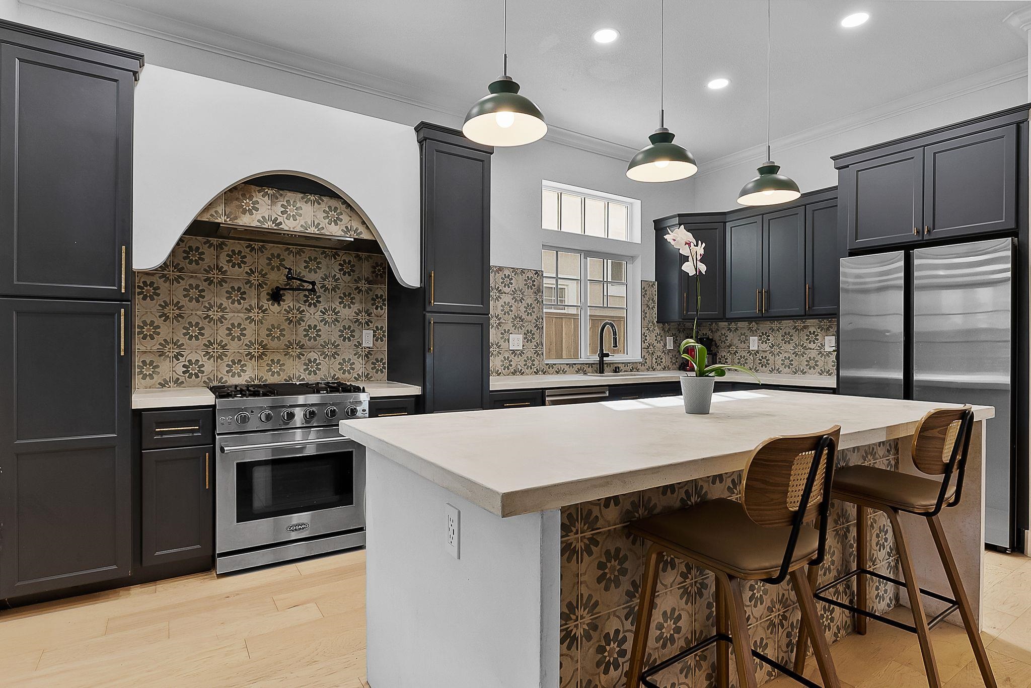 536 Birchwood Road Brentwood, CA 94513 - Photo 13 of 45 Kitchen with stainless steel appliances, a kitchen breakfast bar, a kitchen island, decorative light fixtures, and ornamental molding