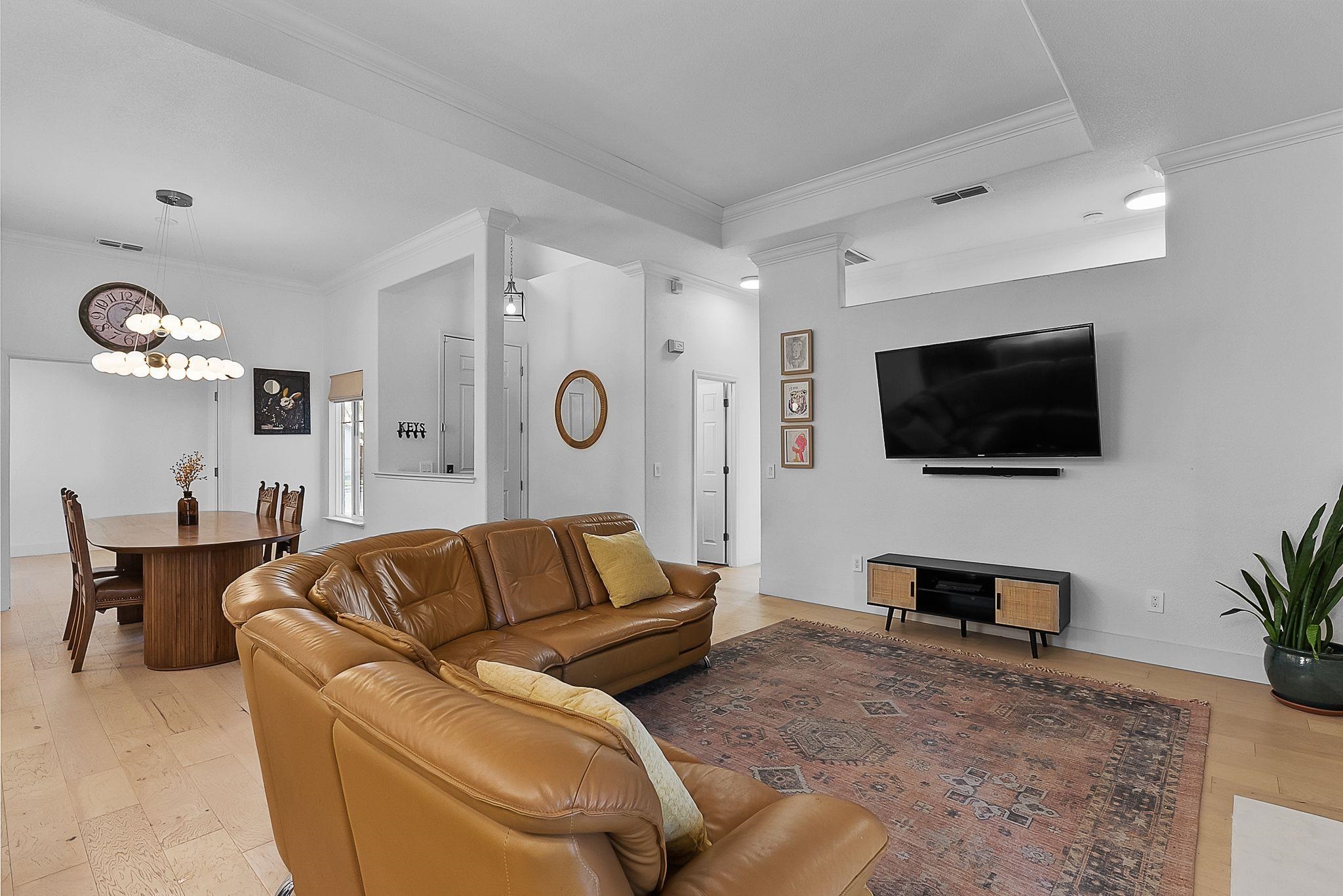 536 Birchwood Road Brentwood, CA 94513 - Photo 19 of 45 Living area with light wood finished floors, crown molding, and suspended lighting