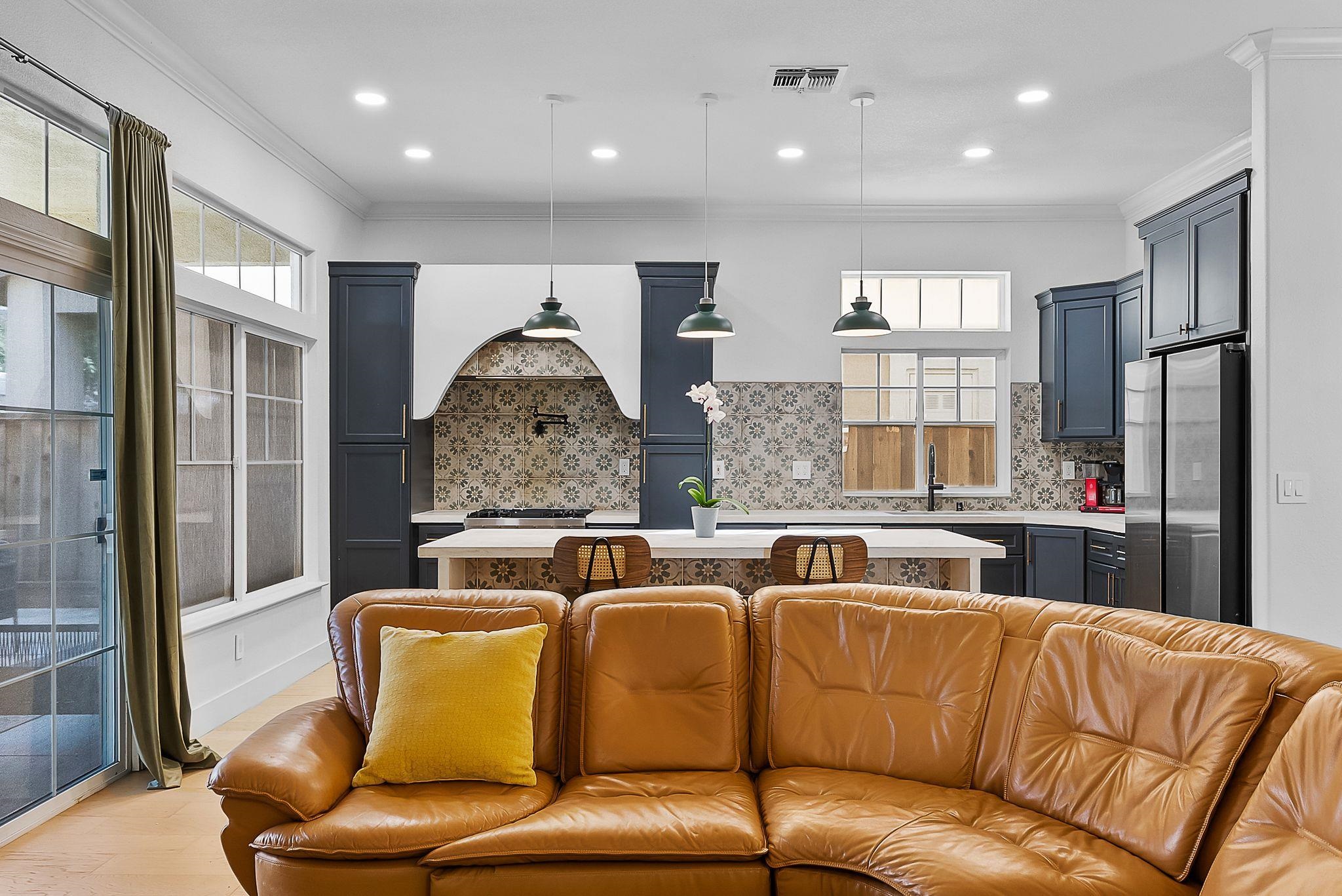536 Birchwood Road Brentwood, CA 94513 - Photo 45 of 45 Kitchen featuring a center island, open floor plan, backsplash, pendant lighting, and crown molding