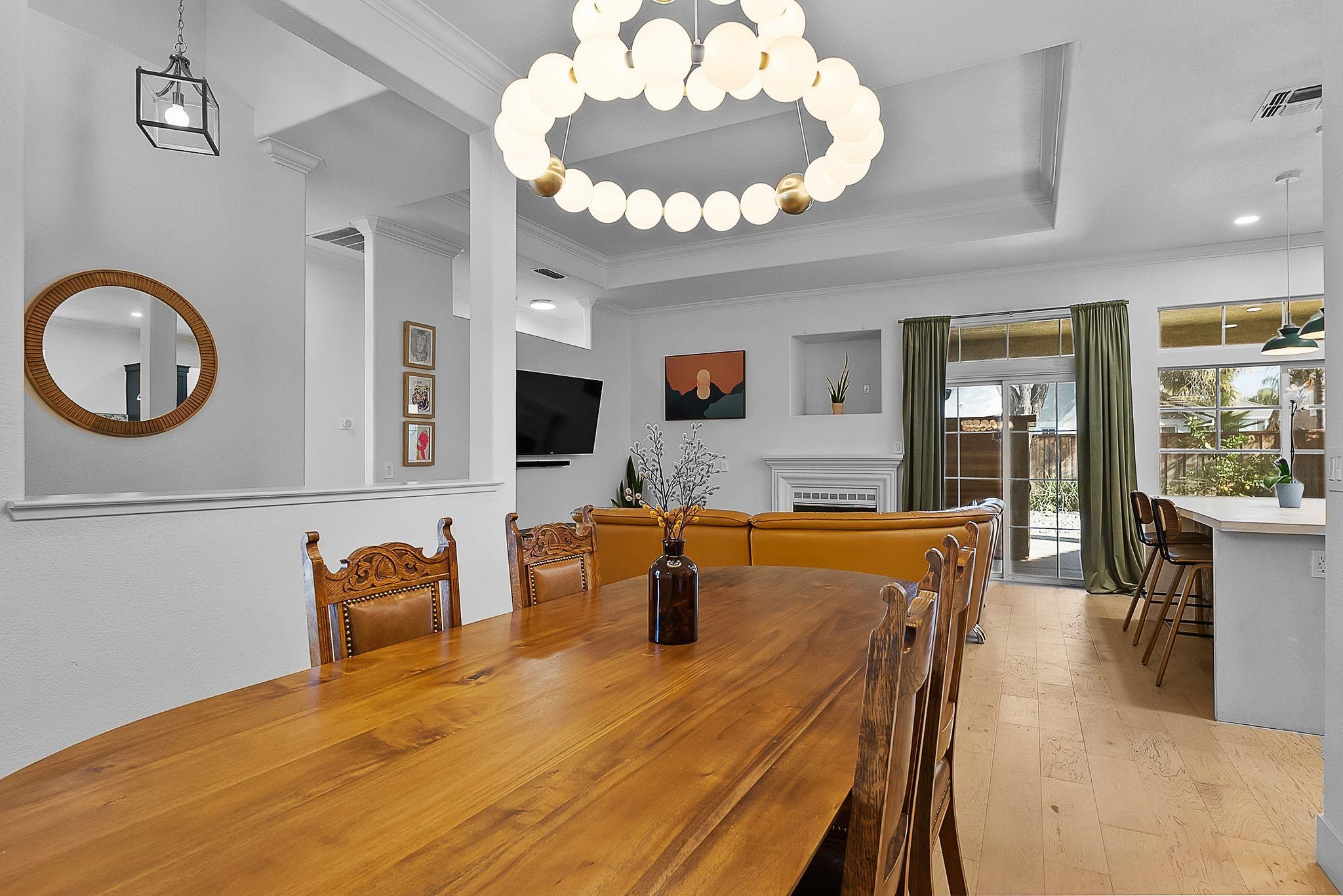 536 Birchwood Road Brentwood, CA 94513 - Photo 6 of 45 Dining room with light wood-style flooring, ornamental molding, suspended lighting, and a raised ceiling