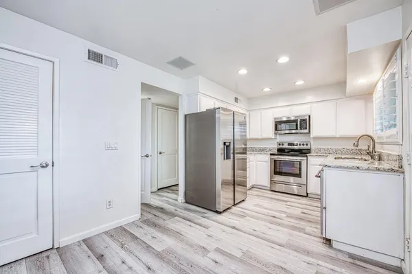 a kitchen with a sink and cabinets