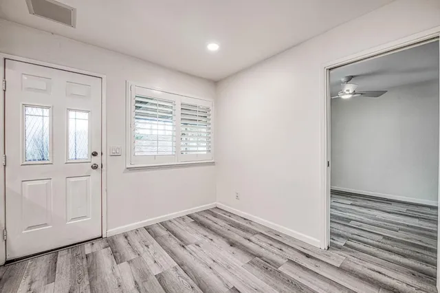 a view of a room with wooden floor and window