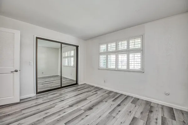 a view of walk in closet with empty racks