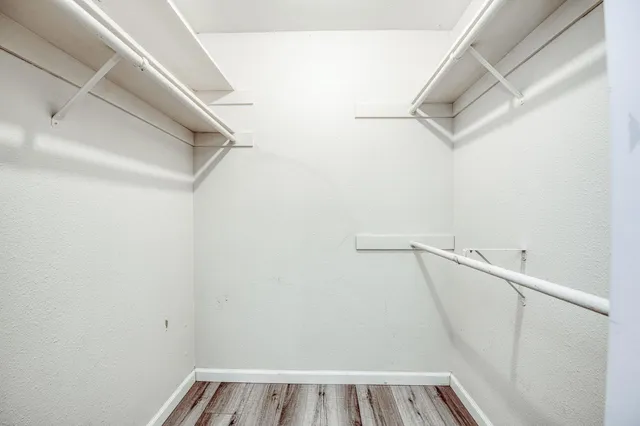 a bathroom with a granite countertop sink and a white cabinets