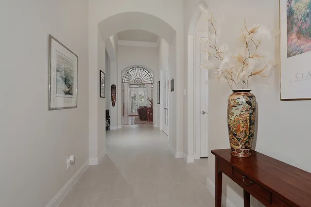 a living room with furniture a large window and a chandelier