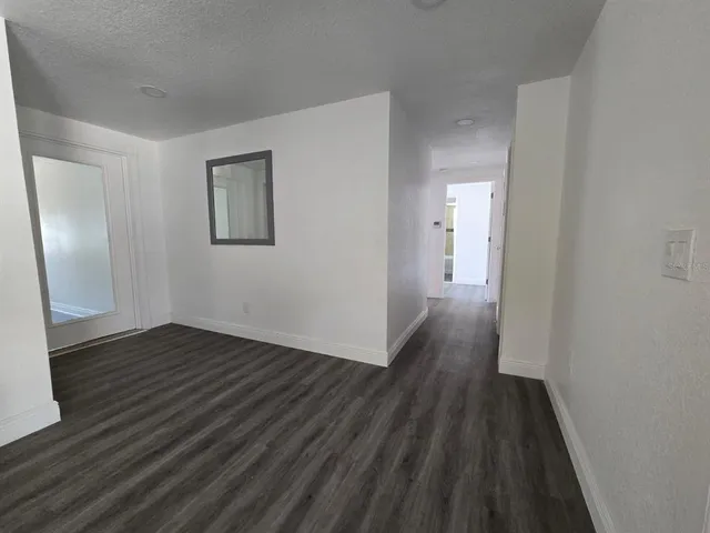 a view of hallway with wooden floor