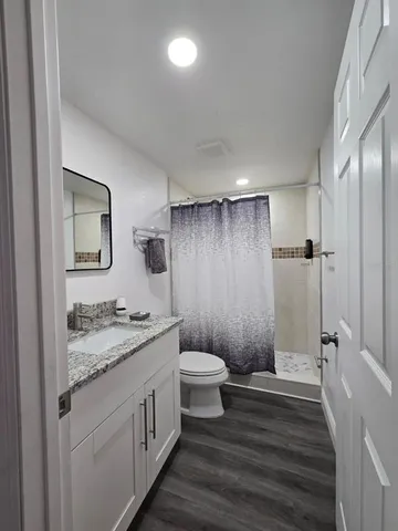 a spacious bathroom with a double vanity sink a mirror and a bathtub