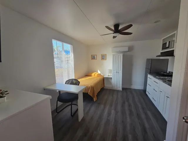 a kitchen with granite countertop a sink stainless steel appliances and cabinets