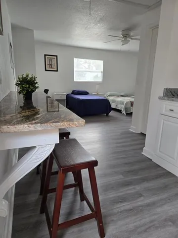 a view of a workspace with furniture and wooden floor