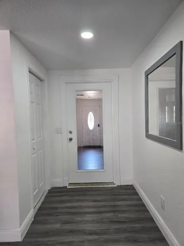 a view of a hallway with wooden floor