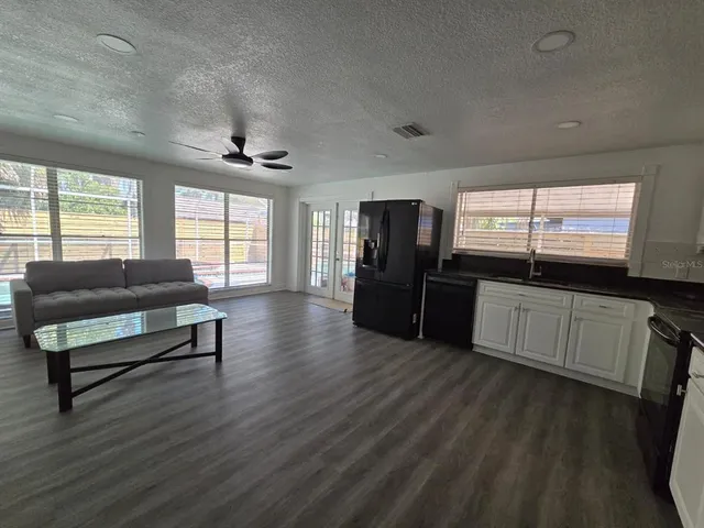 a kitchen with stainless steel appliances a refrigerator and a stove top oven