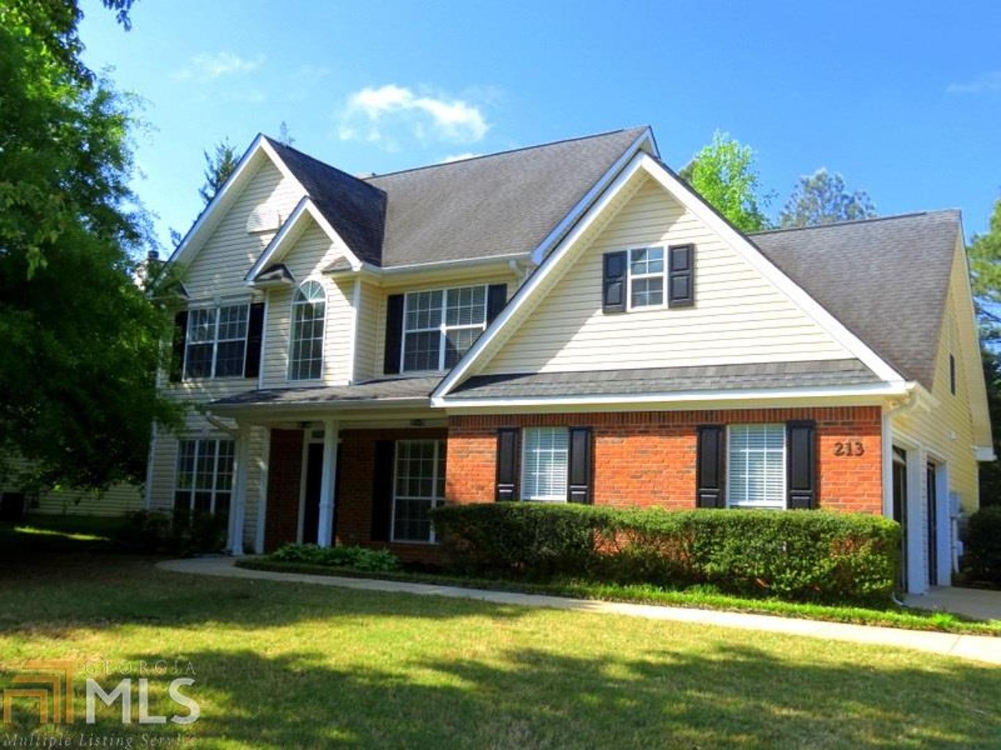 213 Pheasant Ridge Newnan, GA 30265 - Photo 1 of 1 a front view of a house with a yard and garage