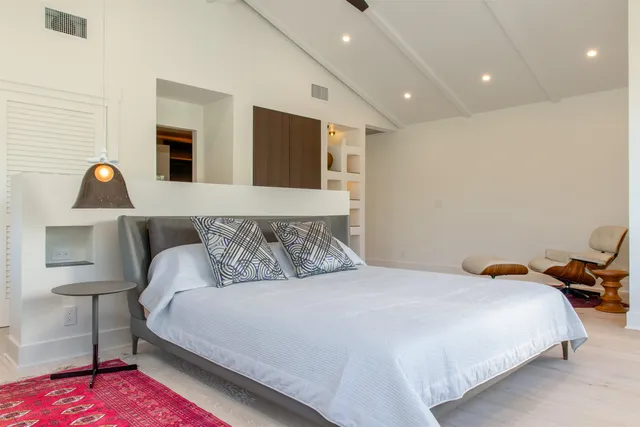 a bedroom with a bed and a lamp