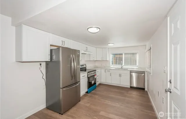 a kitchen with a refrigerator stove and sink