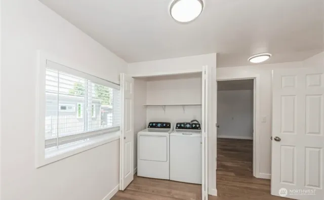 a view of kitchen with wooden floor and electronic appliances