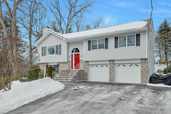 a view of a house with a yard and garage