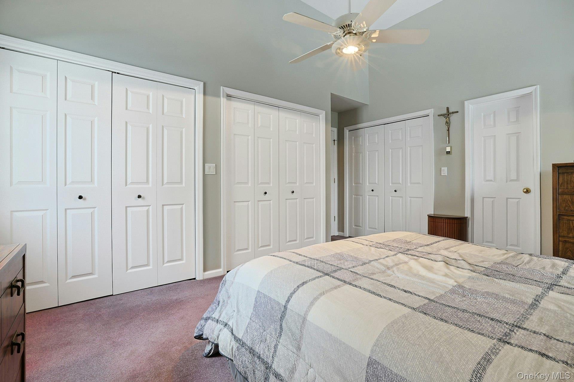 31 West Linwood Street Valhalla, NY 10595 - Photo 17 of 34 a spacious bedroom with a bed and a chandelier