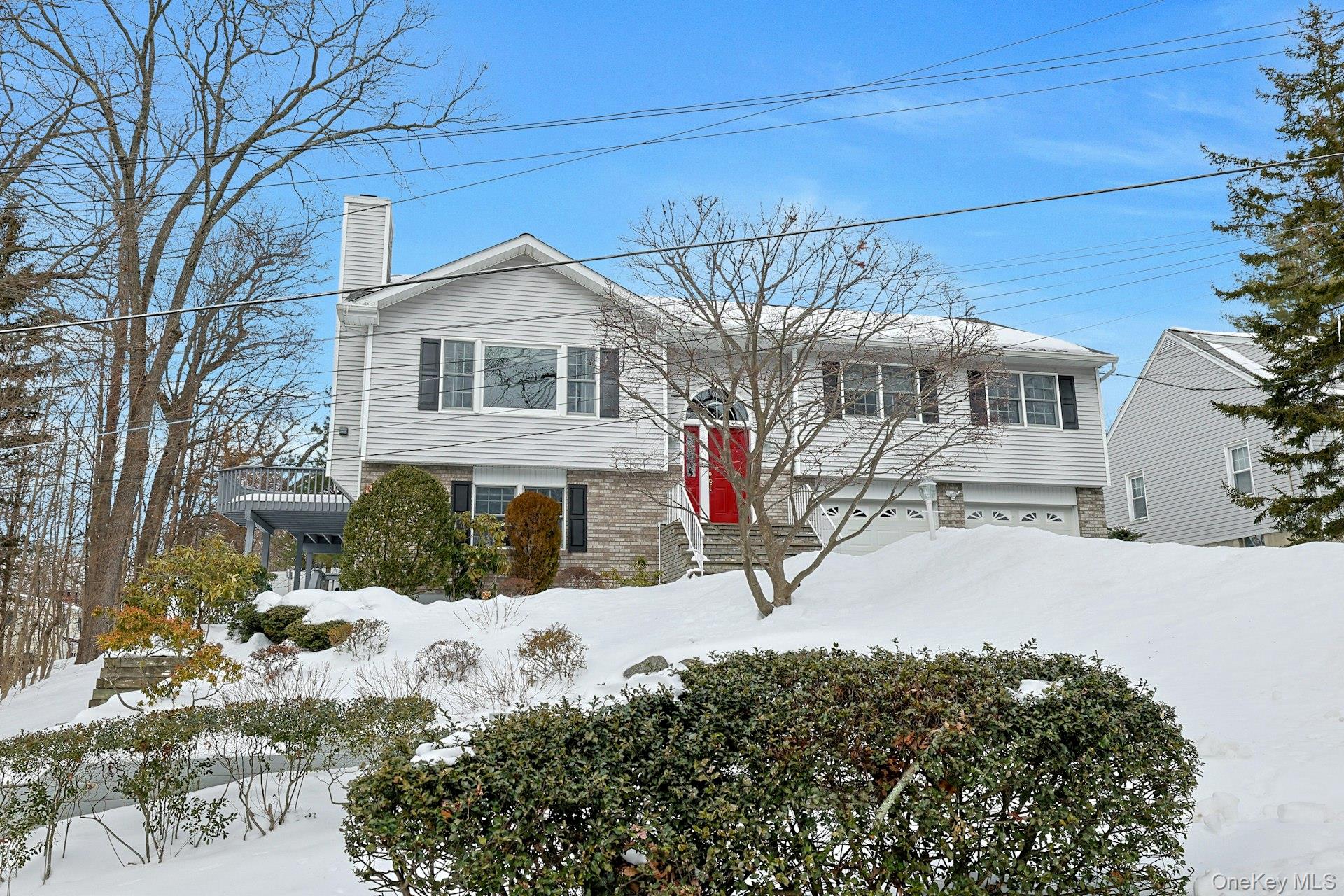 31 West Linwood Street Valhalla, NY 10595 - Photo 3 of 34 a front view of a house with a yard covered in snow