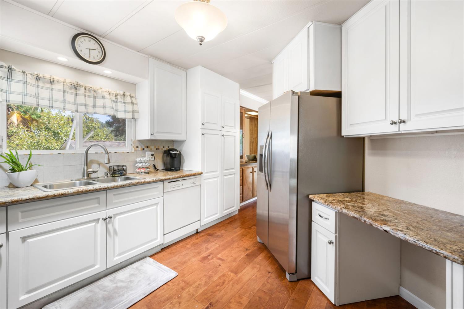 4700 Old French Town Road, Unit 64 Shingle Springs, CA 95682 - Photo 11 of 26 a kitchen with granite countertop white cabinets and stainless steel appliances
