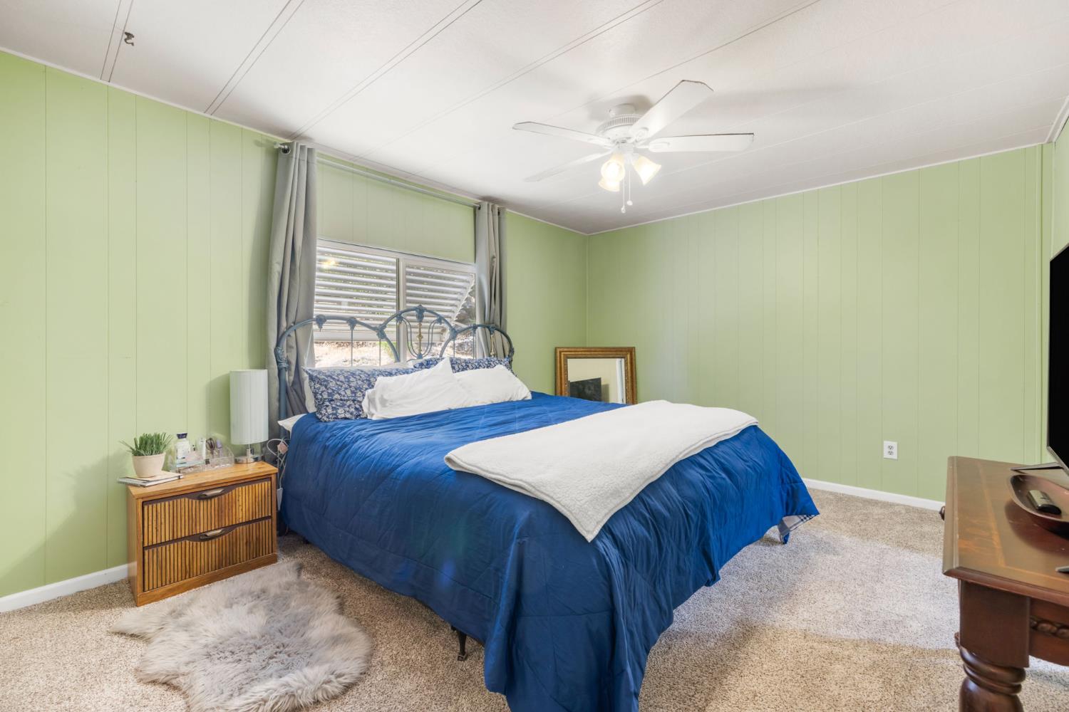 4700 Old French Town Road, Unit 64 Shingle Springs, CA 95682 - Photo 12 of 26 a bedroom with a bed and a chandelier