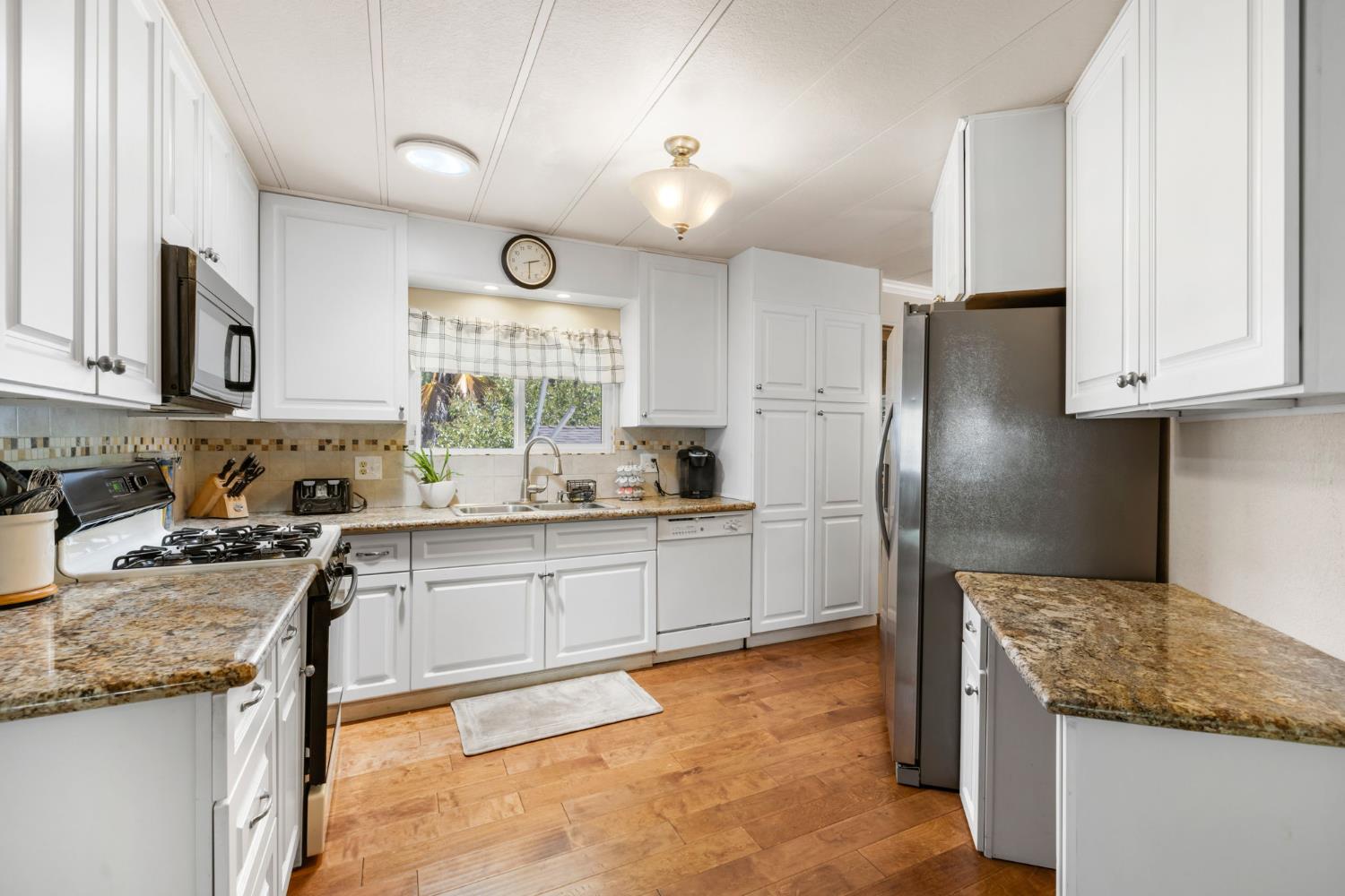 4700 Old French Town Road, Unit 64 Shingle Springs, CA 95682 - Photo 2 of 26 a kitchen with granite countertop stainless steel appliances cabinets a sink and a window