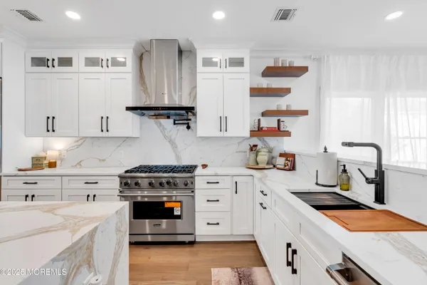 a kitchen with stainless steel appliances granite countertop a stove and a sink
