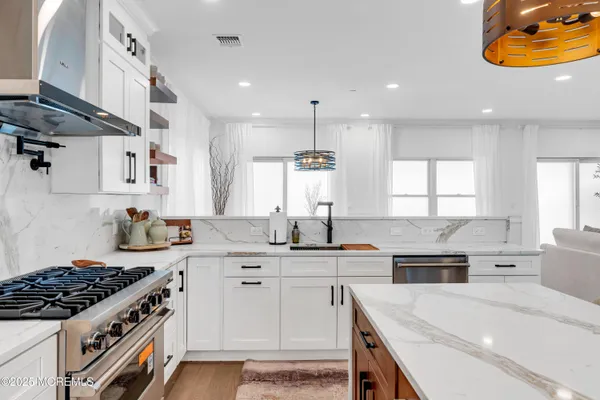 a kitchen with a sink stove and cabinets