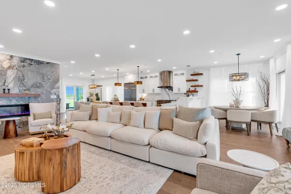 a living room with furniture and a view of kitchen