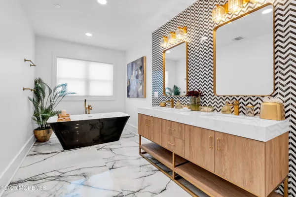 a spacious bathroom with a sink and a mirror