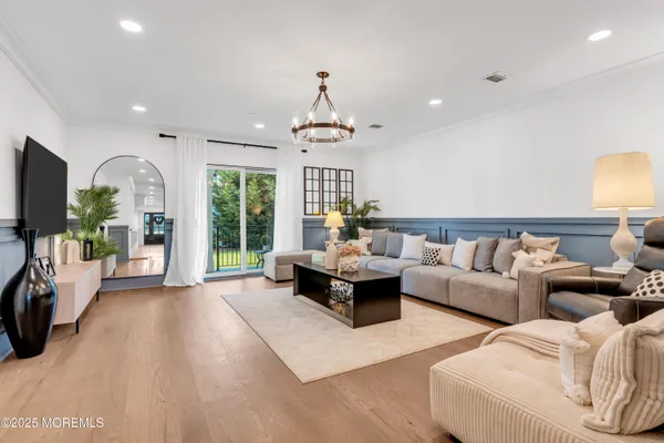 a living room with furniture large window and flat screen tv
