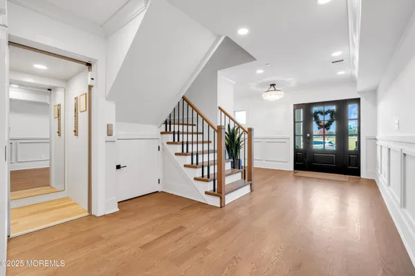 wooden floor with windows and stairs in a room
