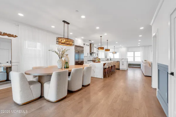 a living room with furniture a table and kitchen view