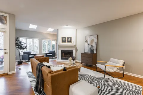 a view of a bedroom with furniture window and wooden floor