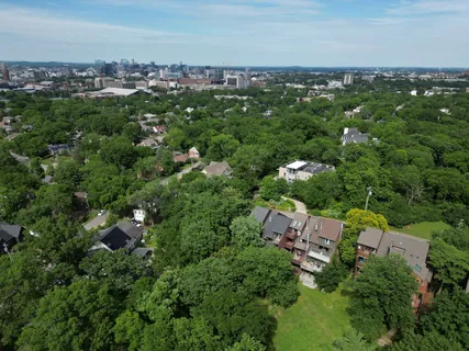 a backyard of a house with lots of plants and tree
