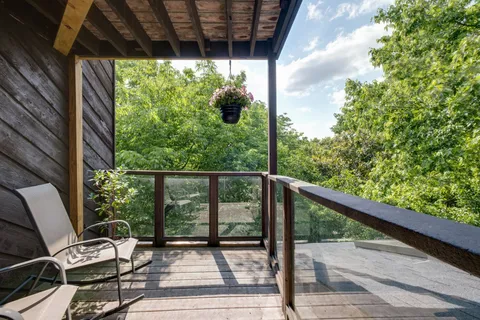 an aerial view of a house with swimming pool and garden