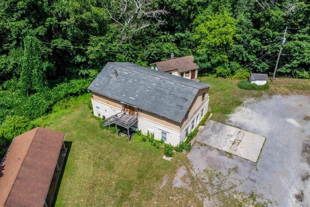 an aerial view of a house with a yard and lake view
