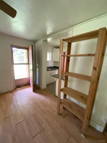 a view of a livingroom with wooden floor and furniture