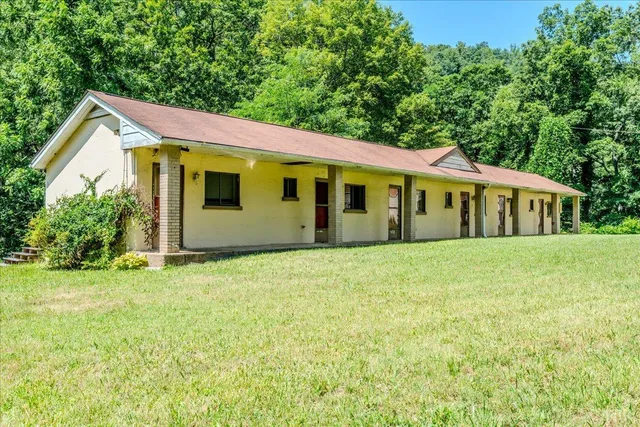 a front view of a house with a garden