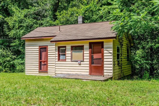a front view of a house with a garden