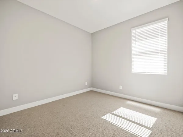 a view of an empty room and wooden floor