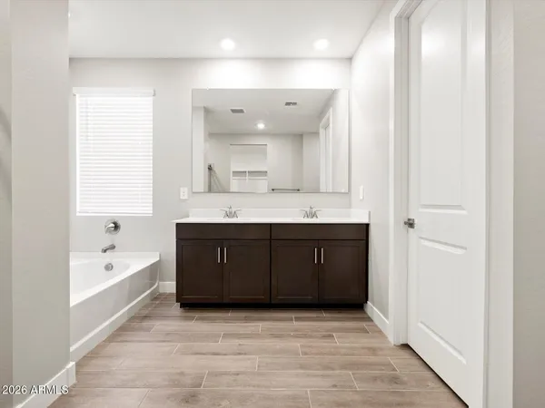 a spacious bathroom with a granite countertop sink mirror and shower