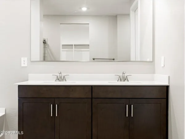 a spacious bathroom with a tub sink and mirror