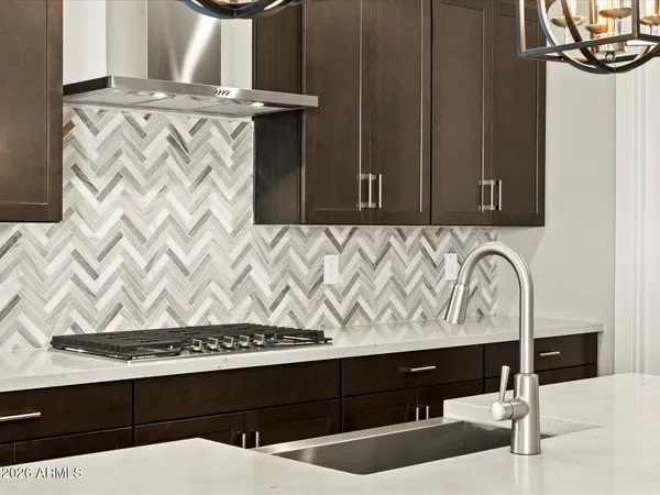 a large kitchen with kitchen island white cabinets and stainless steel appliances
