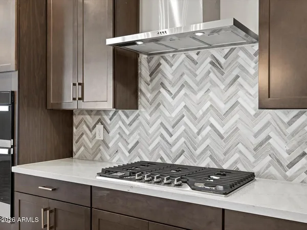 a white stove top oven sitting inside of a kitchen