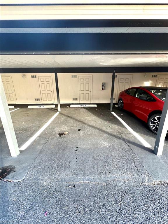 705 Augusta Boulevard, Unit 7059 Naples, FL 34113 - Photo 23 of 26 Carport (2nd parking space) w/Storage
