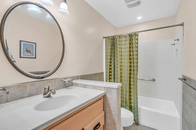 a view of a swimming pool with lawn chairs under an umbrella
